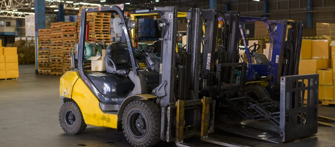 Forklift loader in warehouse, machinery and Logistics concept.